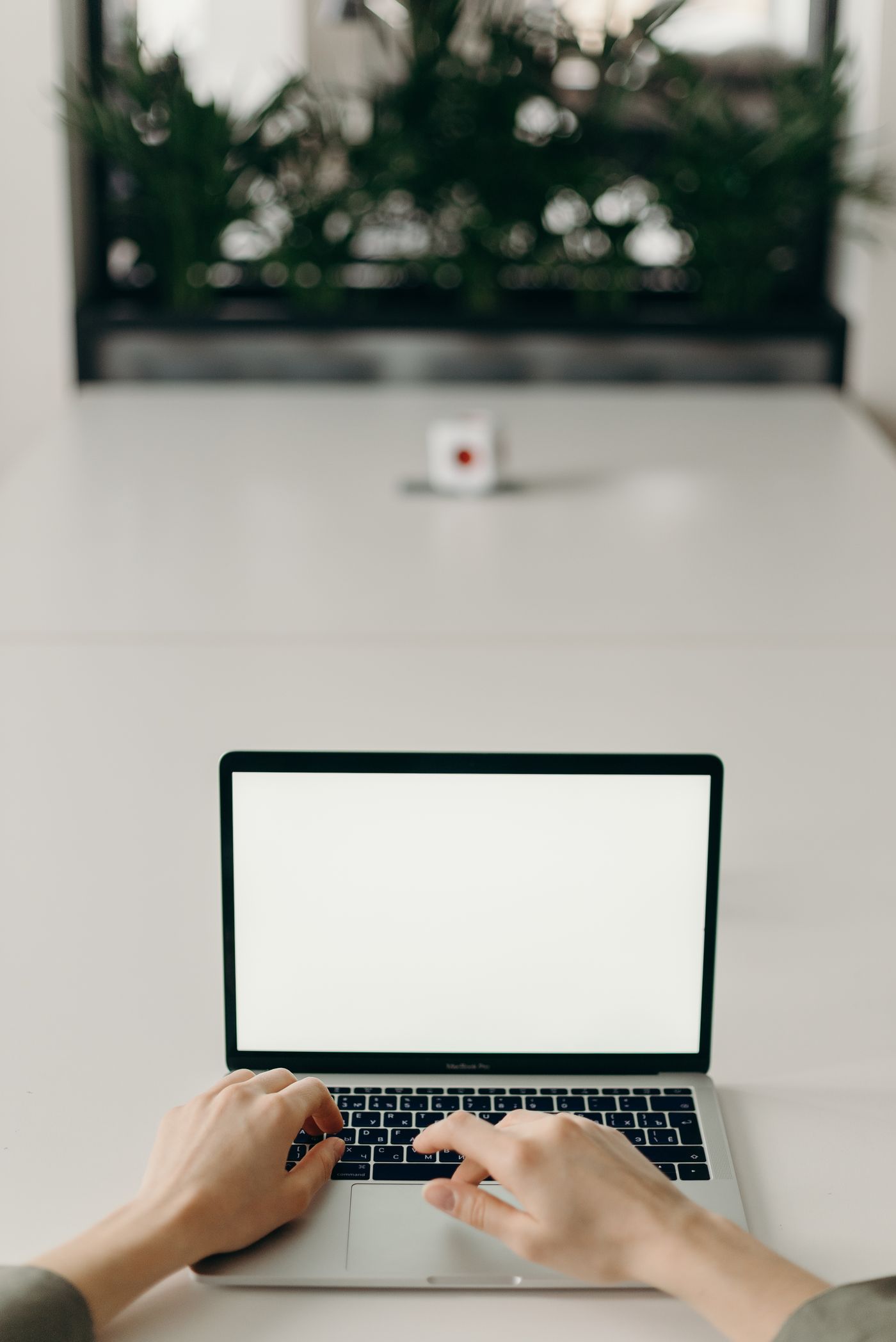 Technology correspondent working at laptop in newsroom